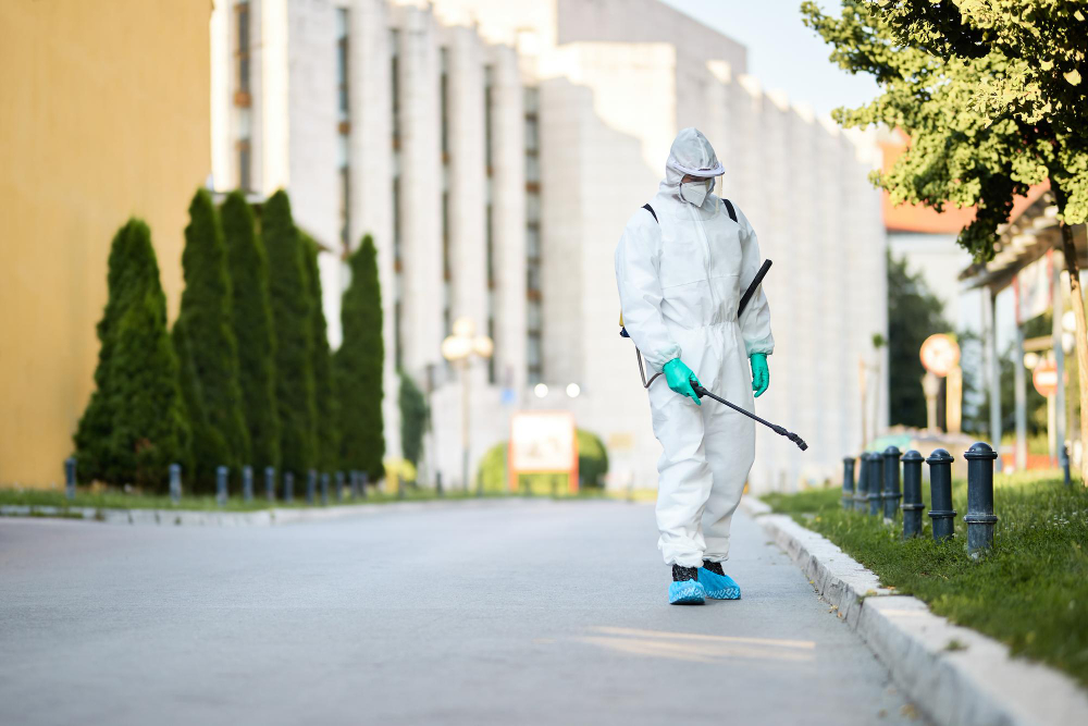 man-protective-suit-disinfecting-city-streets-during-coronavirus-pandemic